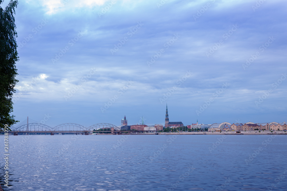 view of the old Riga landscape across the blue river Daugava, in the background a beautiful blue sky