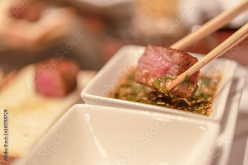 Barbecue rib eye steak, Selected focus on a dry aged Wagyu entrecote steak on chopsticks.