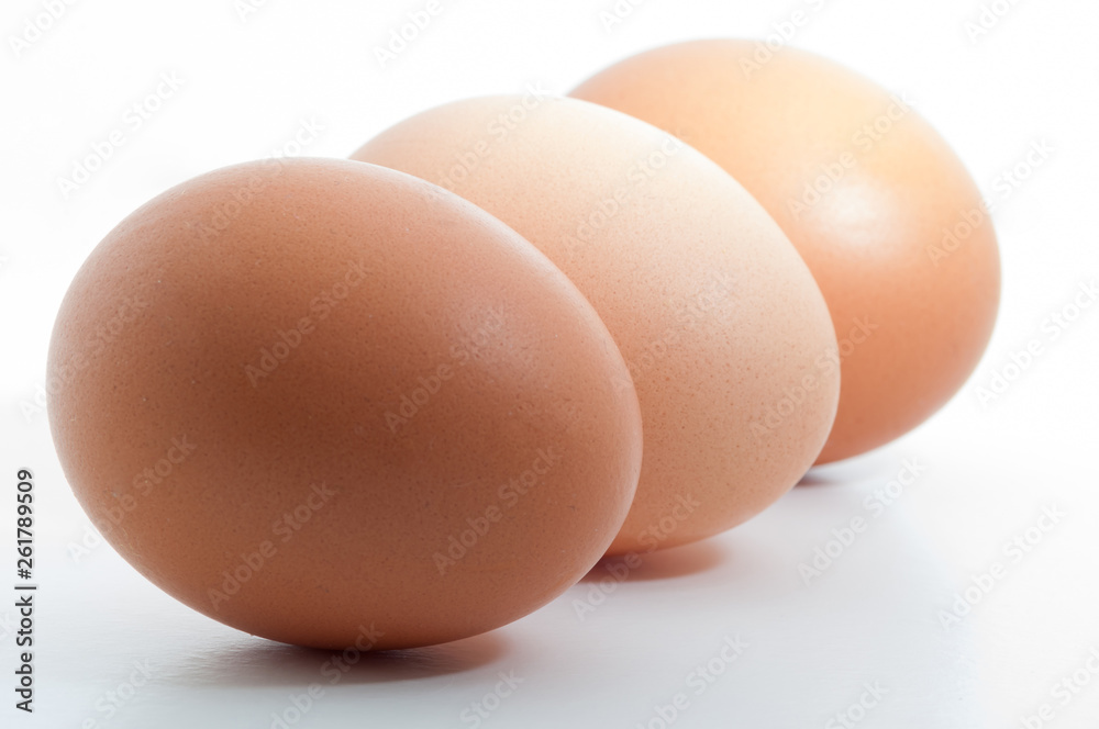 Three eggs in a row isolated on white blank background Three eggs in a row isolated on white blank background
