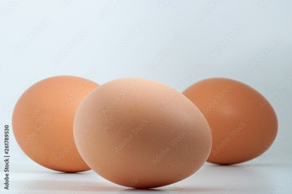 Three eggs in a row isolated on white blank background Three eggs in a row isolated on white blank background