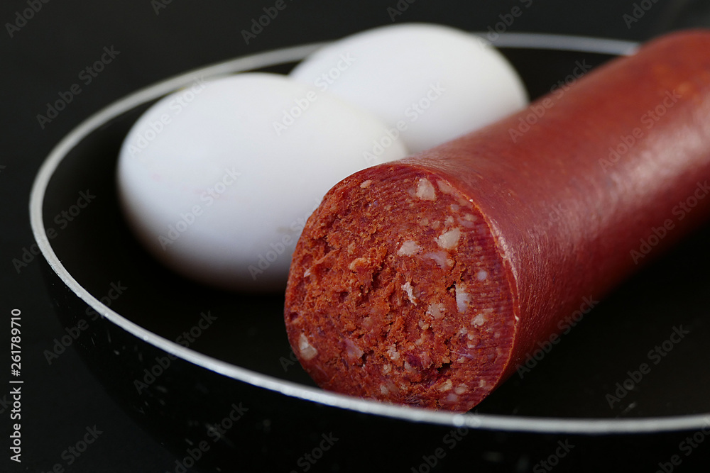 thick veal sausage and egg in frying pan, close-up of veal sausage and egg, thick veal sausage and egg in frying pan, close-up of veal sausage and egg,