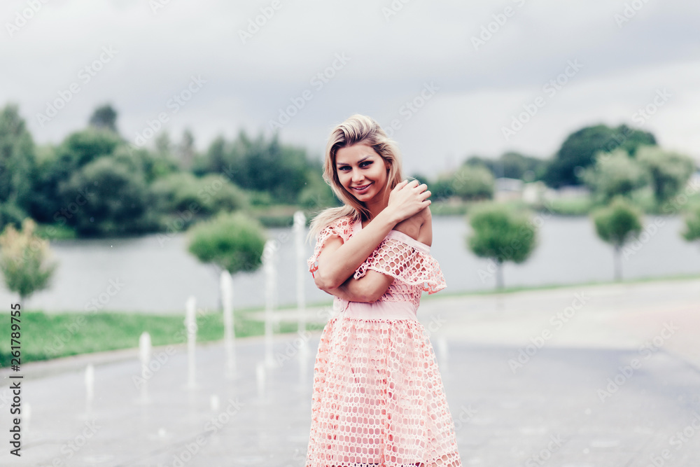 Naklejka premium Portrait of young smiling beautiful woman. Close-up portrait of a fresh and beautiful young fashion model posing outdoors
