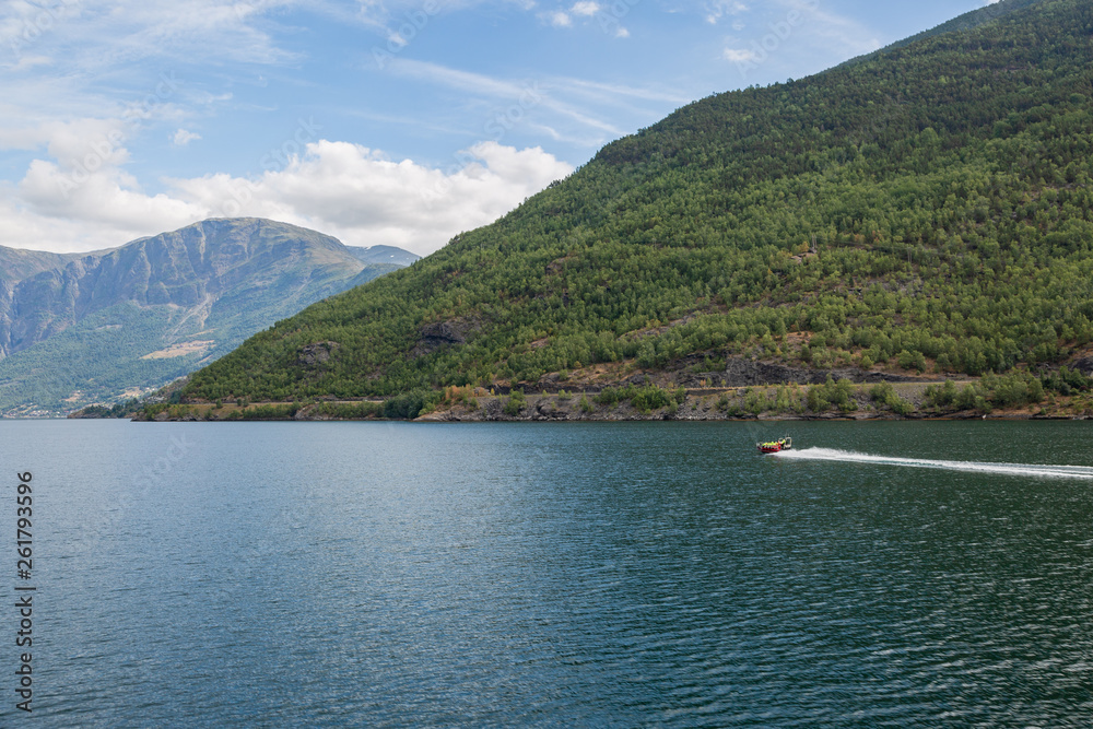 Fjord with a speed boat at the background 