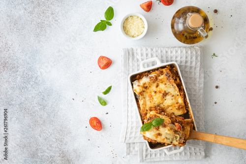 Tasty lasagne with meat, cheese on white plate, top view and copy space photo