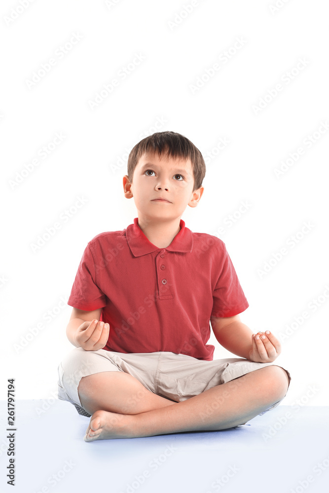 little boy is sitting in the Lotus position.isolated on white little boy is sitting in the Lotus position.isolated on white