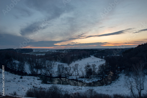 Winter landscape with river and sunset