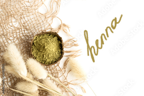 henna powder for dyeing hair and eyebrows and drawing mehendi on hands,  with green palm leaf photo