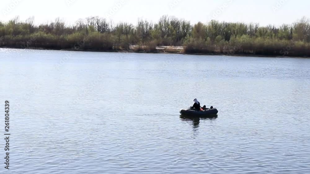Fisherman fishing on the river from a boat. Fishing. A fish. Fishing rod. Fisherman. Catching. River. Water.