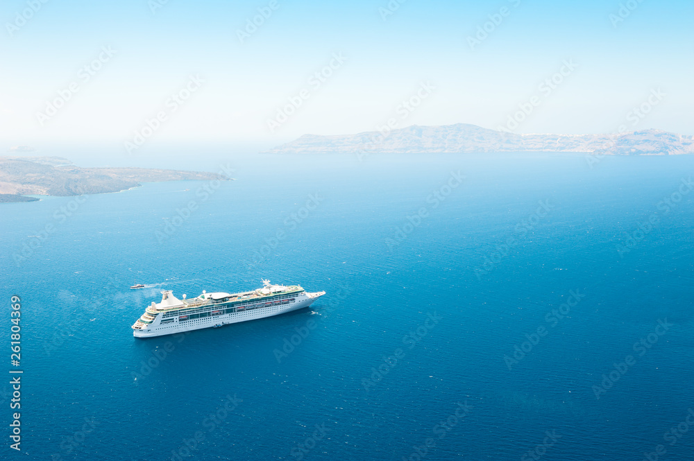 Cruise ship in the sea near the Santorini island, Greece.