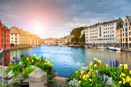 Beautiful promenade with flowers on the canal in Alesund, Norway. photo