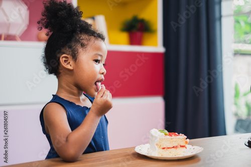 african girl kid eating sweet cake