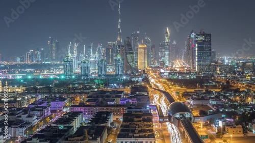 Wallpaper Mural Dubai skyline with beautiful city center lights and Sheikh Zayed road traffic night timelapse. Illuminated towers and skyscrapers aerial view from zabeel district. Dubai, United Arab Emirates Torontodigital.ca