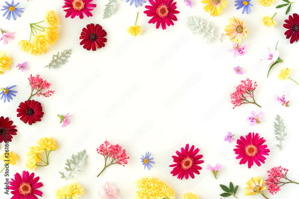 Floral pattern with spring flowers and leaves on white background with copy space. Flat lay. Top view