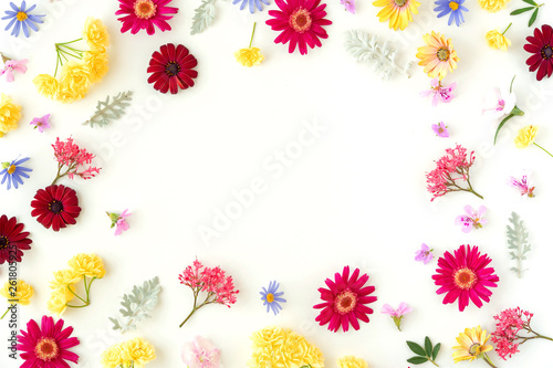 Fototapeta Naklejka Na Ścianę i Meble -  Floral pattern with spring flowers and leaves on white background with copy space. Flat lay. Top view