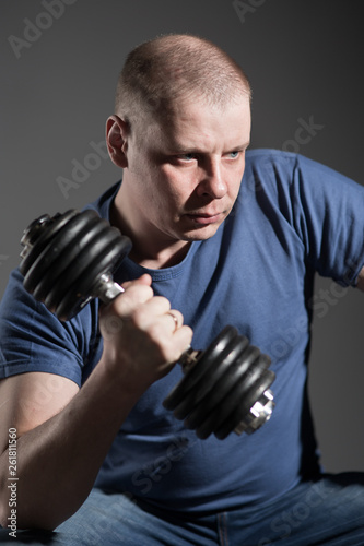 Young male dumbbell in his hands © Evgenia Tiplyashina