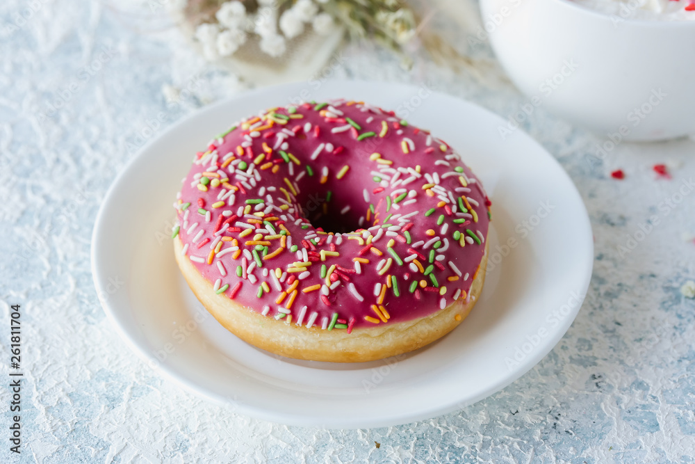 Berry pink donut on a plate. Top view Berry pink donut on a plate. Top view