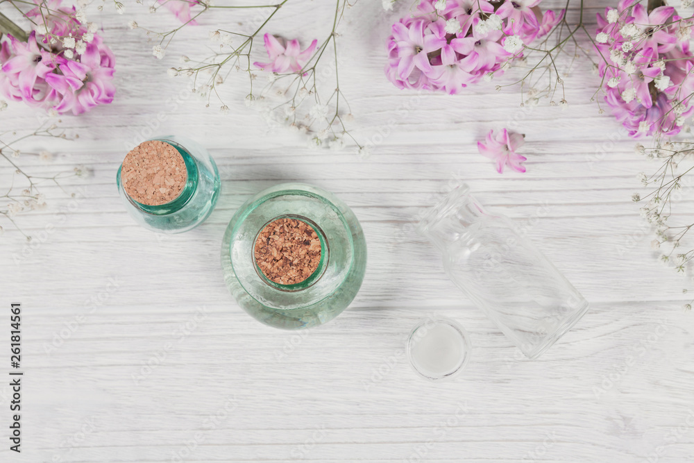Abstract composition of purple hyacinths flowers and bottles of organic cosmetic with essential oil Abstract composition of purple hyacinths flowers and bottles of organic cosmetic with essential oil