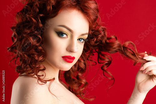 gorgeous woman with red hair and bright makeup closeup