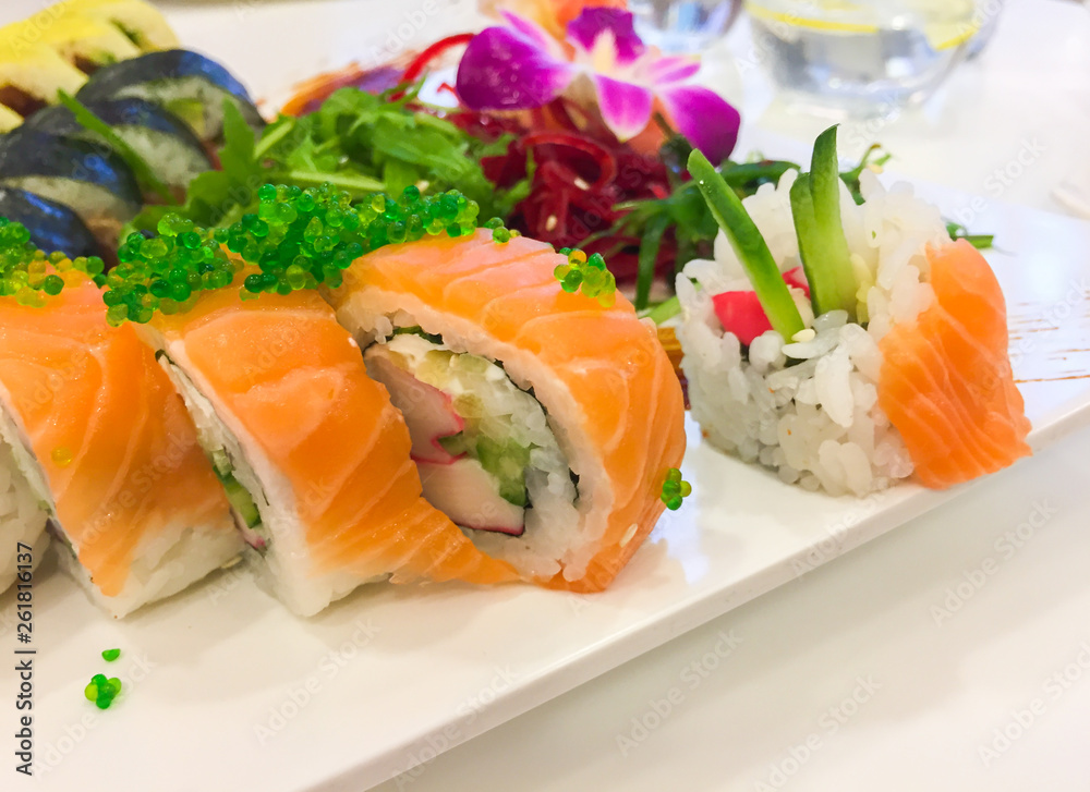 Variety of sushi rolls on a white plate