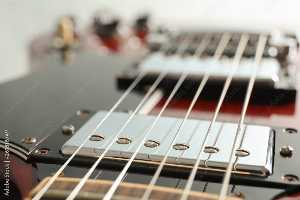 Beautiful six - string electric guitar on white background, closeup Beautiful six - string electric guitar on white background, closeup
