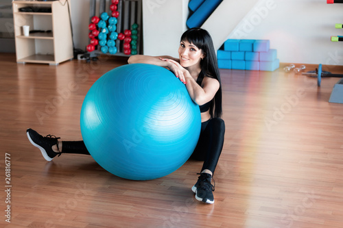 Fitness woman exercise with ball in gym. Individual sport to fit muscles of body for healthy life concept.