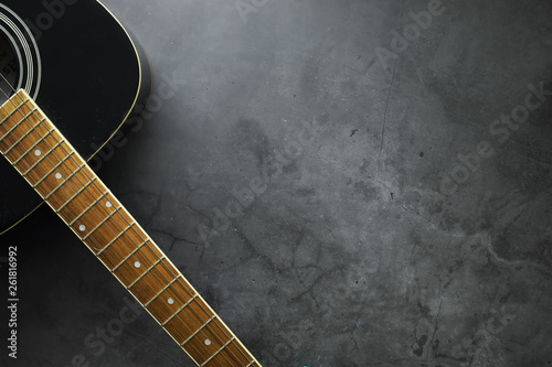 Guitar and accessories on a stone background. Desk musician, headphones, microphone. photo