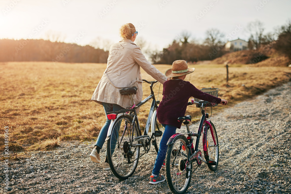 Mother and daughter with bicycles on countryside. Mother and daughter with bicycles on countryside.