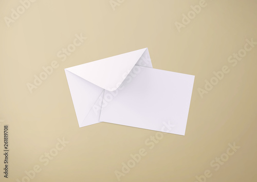 White postcard and envelope on background, top view. Blank envelope mockup and letterhead presentation template. Postcard flyer for your design.