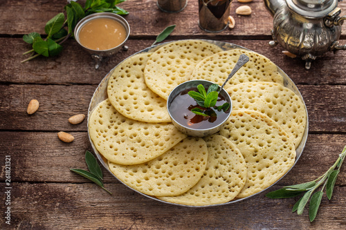 Moroccan breakfast with Baghrir, mint tea and honey, copy space photo