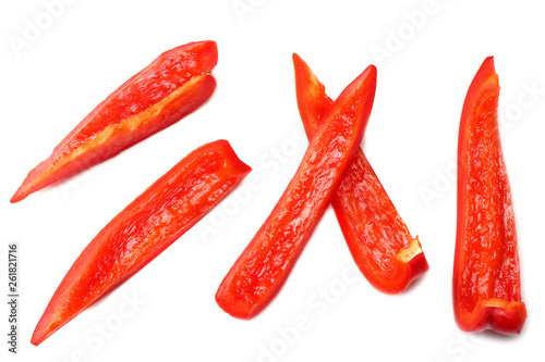 cut slices of red sweet bell pepper isolated on white background top view