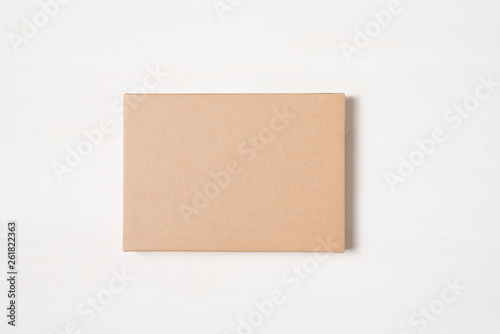 Kraft brown rectangular gift box on a light background © somemeans