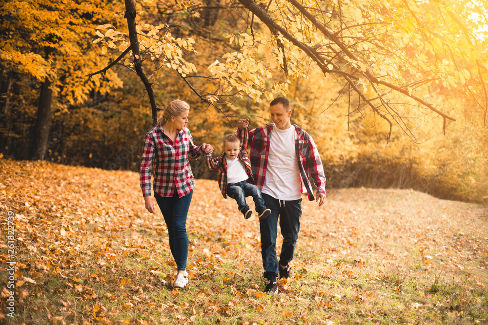 Little cute son playing with parents in forest Little cute son playing with parents in forest