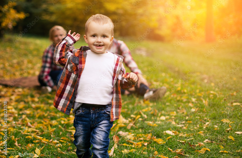 Little cute son playing with parents in forest Little cute son playing with parents in forest