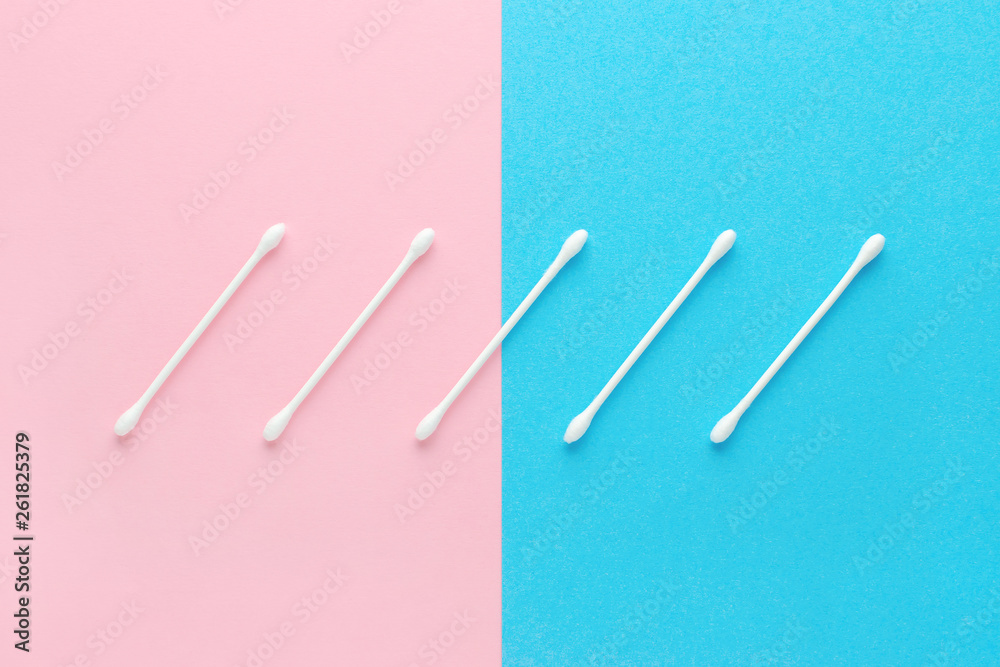 white cotton swabs on pink and blue background white cotton swabs on pink and blue background