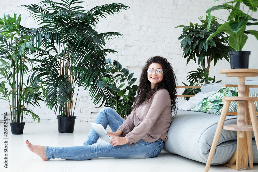 Portrait of an attractive young woman using a digital tablet Portrait of an attractive young woman using a digital tablet