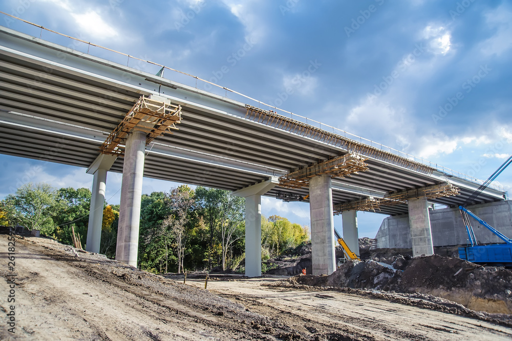 Construction of a bridge against the background of forest and sky Construction of a bridge against the background of forest and sky