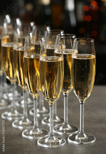 Glasses of champagne on table against blurred background