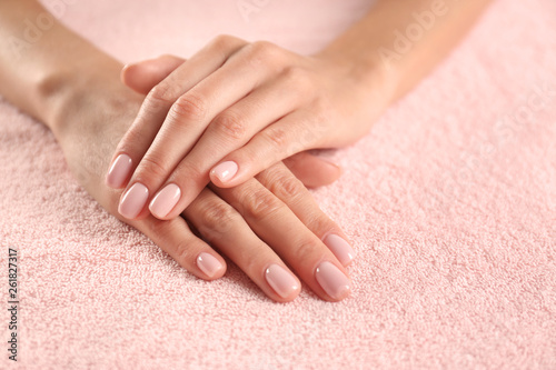 Closeup view of beautiful female hands on towel  space for text. Spa treatment