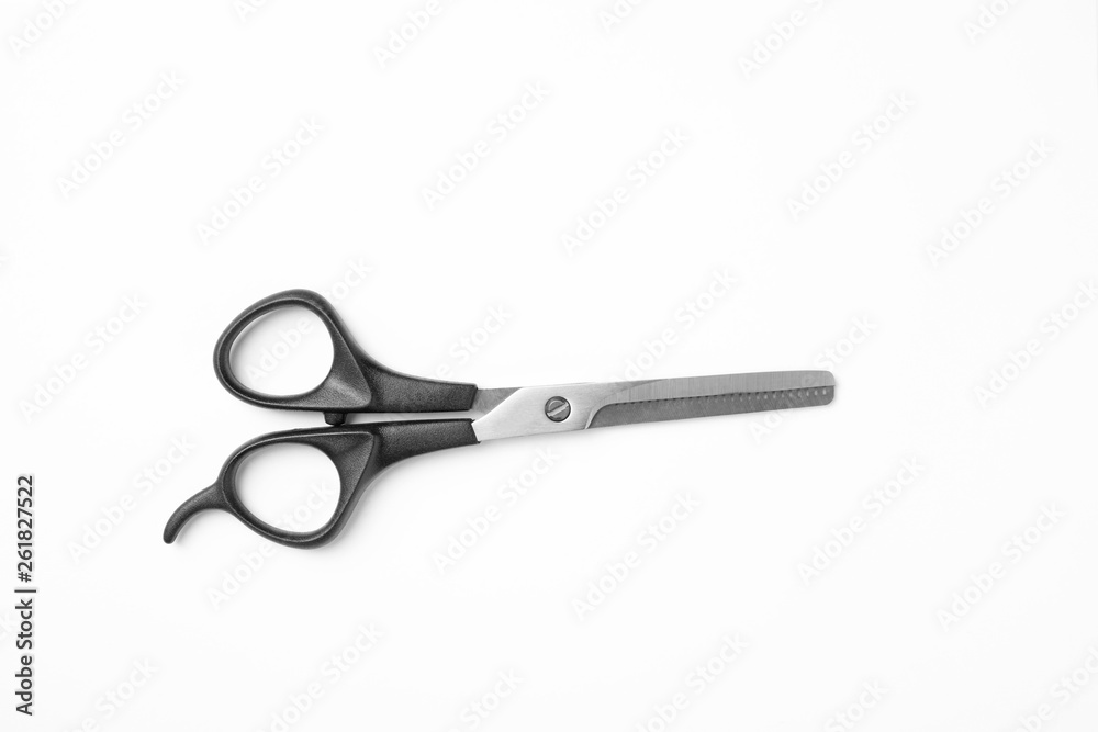 New thinning scissors on white background, top view. Professional hairdresser tool New thinning scissors on white background, top view. Professional hairdresser tool