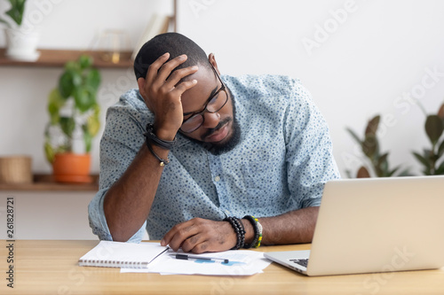 Tired depressed bored african businessman frustrated by business failure photo