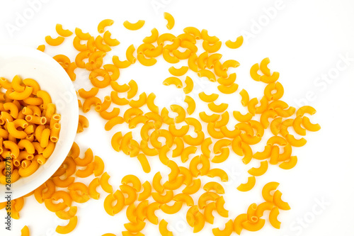 Uncooked elbow macaroni background isolated on white, top view. 