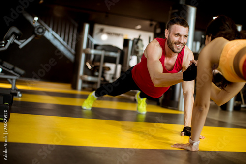 Fit sportive man and woman doing plank core exercise