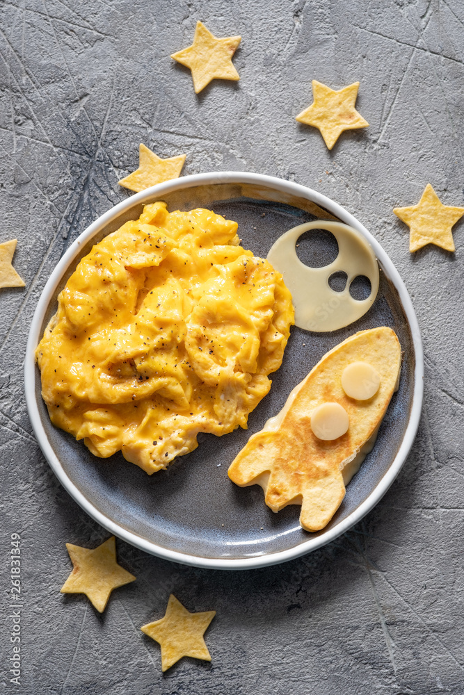 Kids funny breakfast with scrambled eggs, cheese and tortilla rocket Kids funny breakfast with scrambled eggs, cheese and tortilla rocket