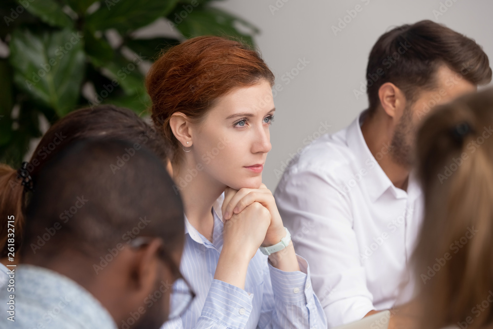 Thoughtful businesswoman thinking of business challenges opportunities at group meeting Thoughtful businesswoman thinking of business challenges opportunities at group meeting
