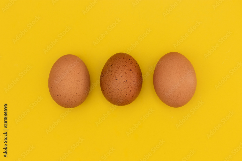 three easter eggs laying on a yellow background three easter eggs laying on a yellow background