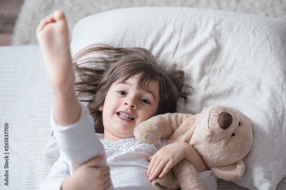 Little cute girl in bed with toy Little cute girl in bed with toy