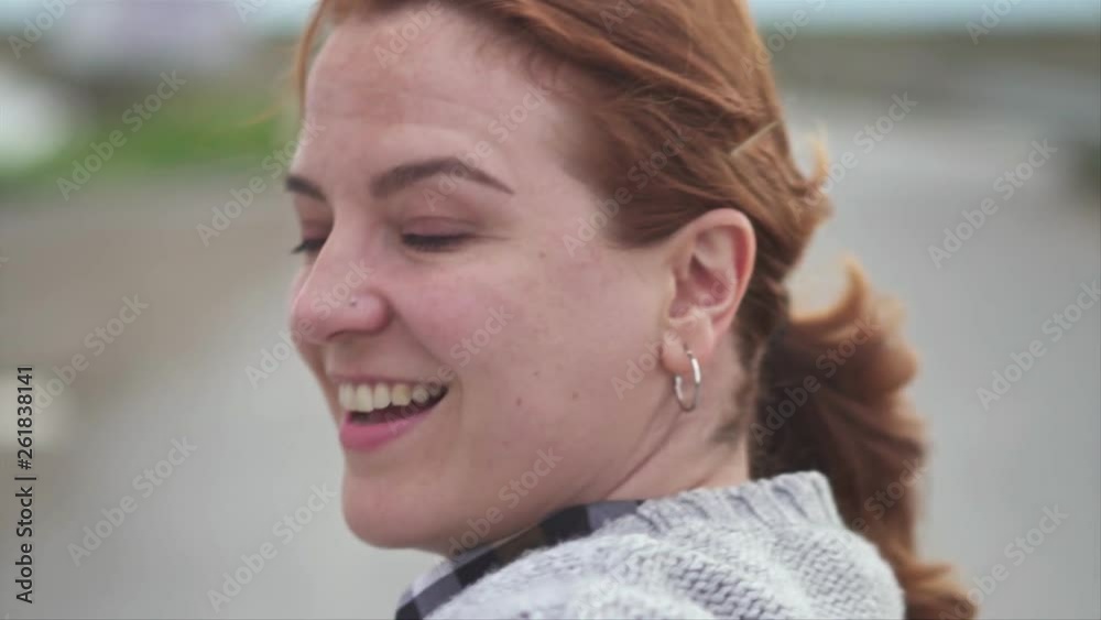 Woman walking, back side and turns to camera, slow motion video, shot with gimbal Woman walking, back side and turns to camera, slow motion video, shot with gimbal