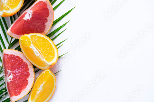 Template for tropical banner with palm leaf  grapefruit and orange on a white background. Frame for text with citrus. Tropical banner design over a white background. View from above