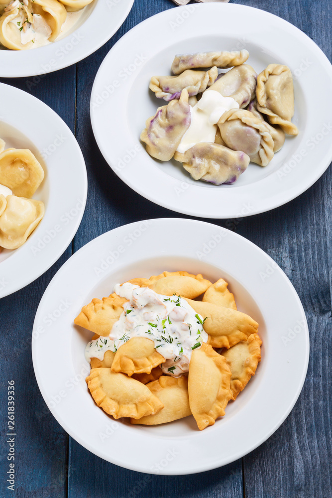 Variety of dumplings on a blue wooden table Variety of dumplings on a blue wooden table