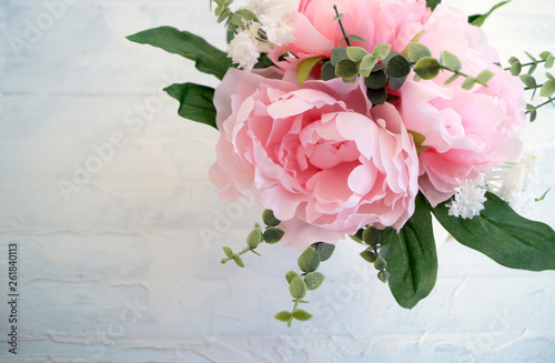 Fototapeta Naklejka Na Ścianę i Meble -  Pink artificial peonies on a light background.